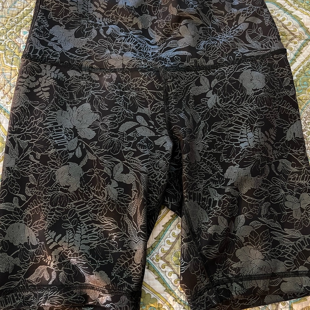 Lululemon bike shorts. Black with green foil print.
